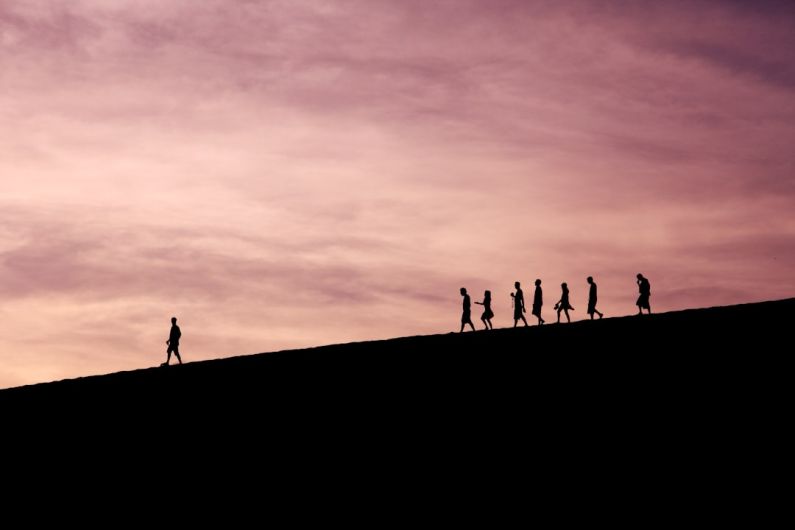 Authentic Leadership - silhouette of people on hill