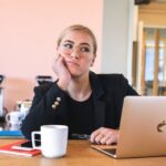 Positive Procrastination - woman in black long sleeve shirt using macbook