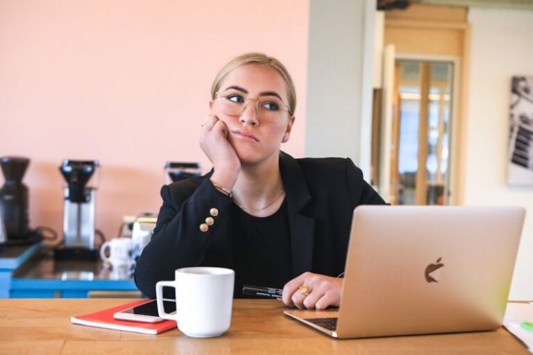 Positive Procrastination - woman in black long sleeve shirt using macbook