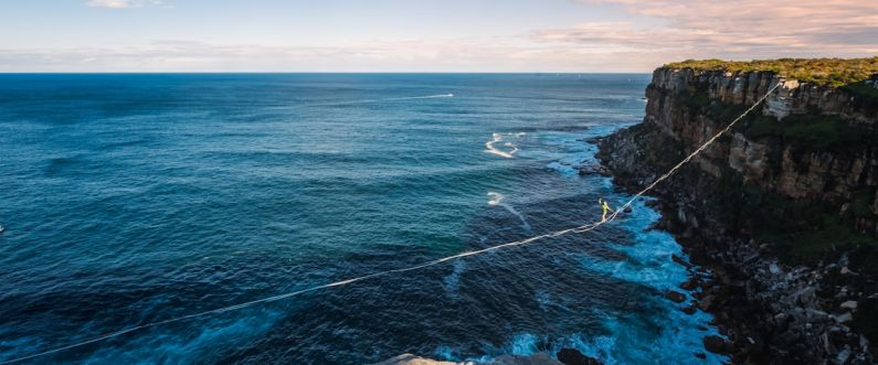 Change Resilience - a rope is attached to the edge of a cliff near the ocean