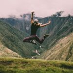 Life Stages - woman jumping on green mountains