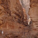 Adversity Resilience - a person standing in a narrow canyon between two mountains