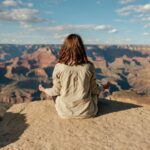Stress Management - woman sitting on hill