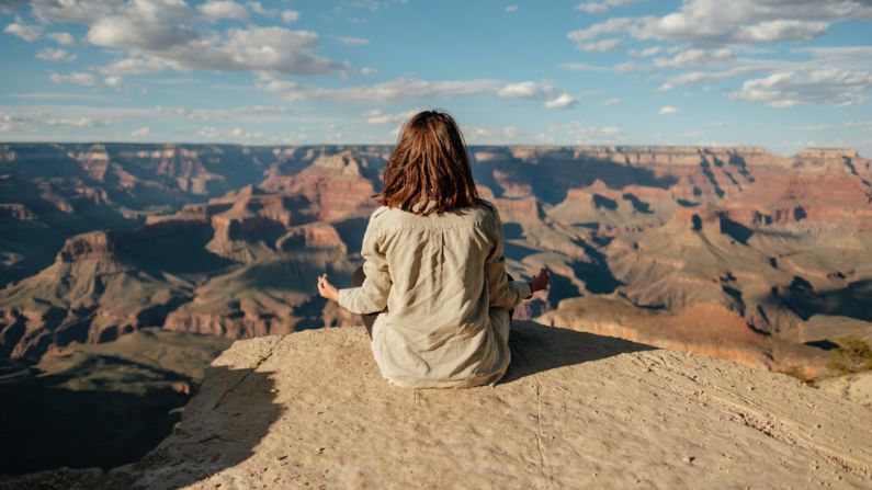 Stress Management - woman sitting on hill